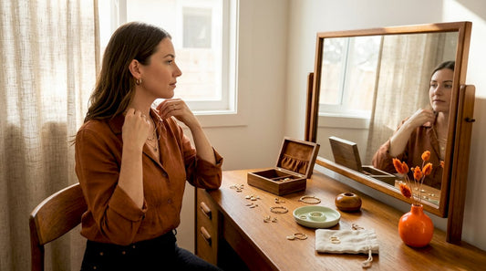 Woman comparing jewelry pieces at vanity