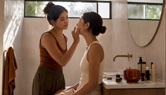 Makeup artist prepping client's skin