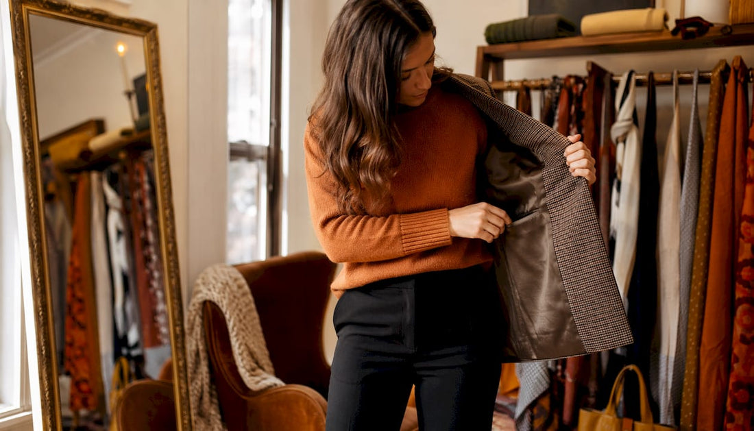 Woman inspecting jacket pocket indoors