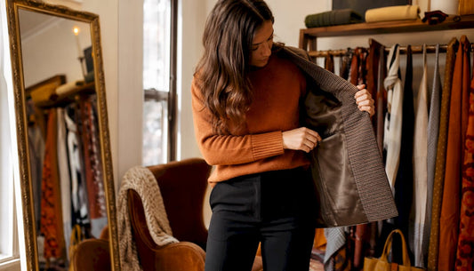 Woman inspecting jacket pocket indoors