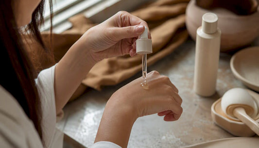 Hands applying skincare serum in beauty studio