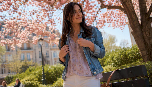 Woman adjusting spring layered outfit outdoors