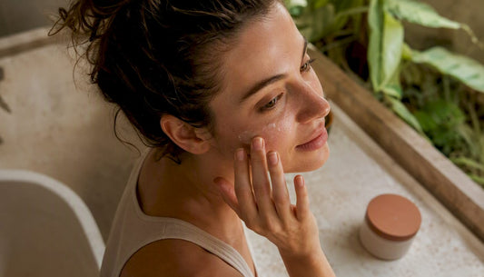 Woman applying face primer with fingers