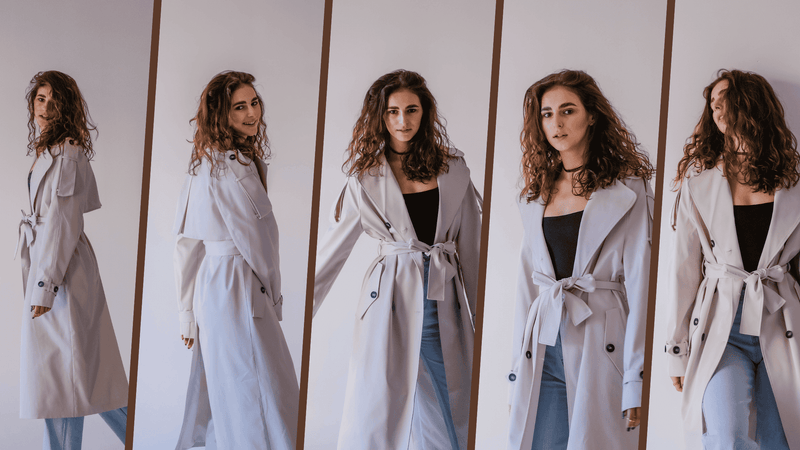 Woman modeling beige trench coat and jeans, autumn fashion collection, indoor studio