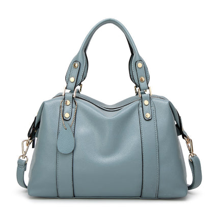 Blue leather handbag with gold hardware, double handles, and detachable shoulder strap