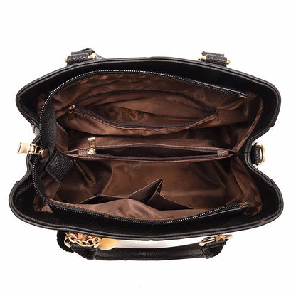 Top view of black leather handbag interior with brown lining and multiple zippered pockets