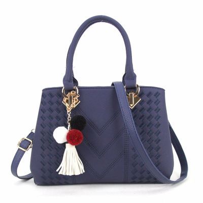 Navy blue textured handbag with gold hardware and pom tassel charm