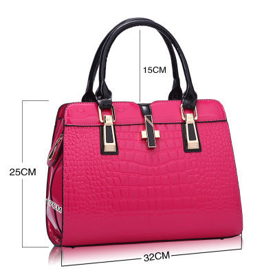 Pink crocodile pattern handbag with black handles and gold accents, 32x25x15cm dimensions