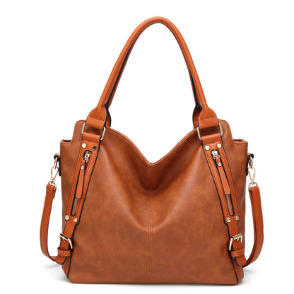 Brown leather tote handbag with gold hardware and adjustable shoulder straps on white background