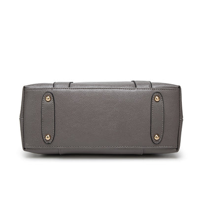 Gray leather handbag bottom with gold feet on white background