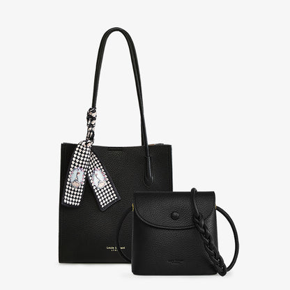 Black tote bag with patterned scarf and matching small crossbody purse on white background